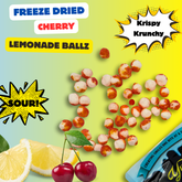 Freeze-dried cherry lemon ballz with lemon slices and cherries on a colorful background.